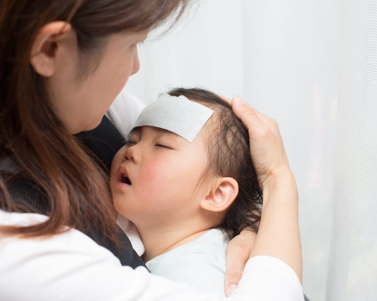 発熱してだっこされている子供